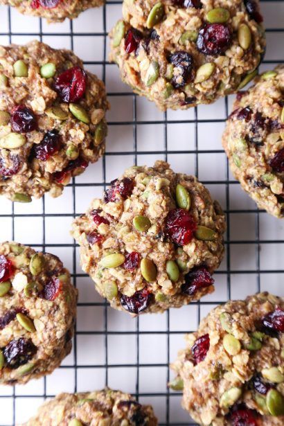 Healthy oatmeal cookies with cranberries and pumpkin seeds on a cooling rack.