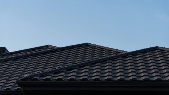 Modern tiled roof against clear blue sky, highlighting durable and stylish roofing materials.