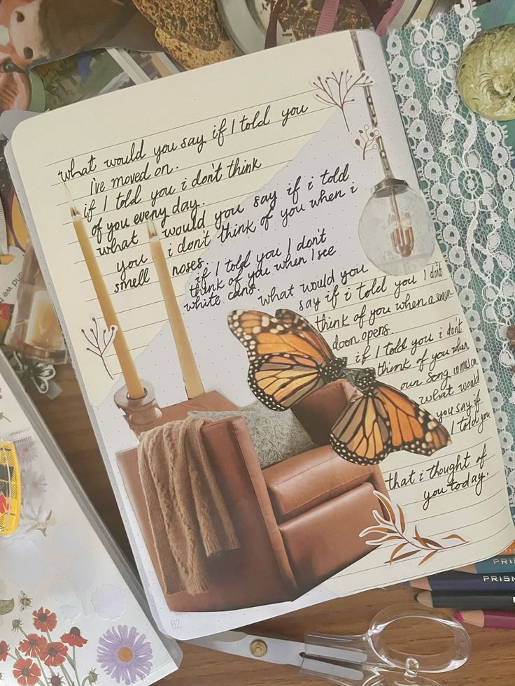 Open journal with handwritten text, cut-out butterfly, lace decoration, and a cozy chair scene.