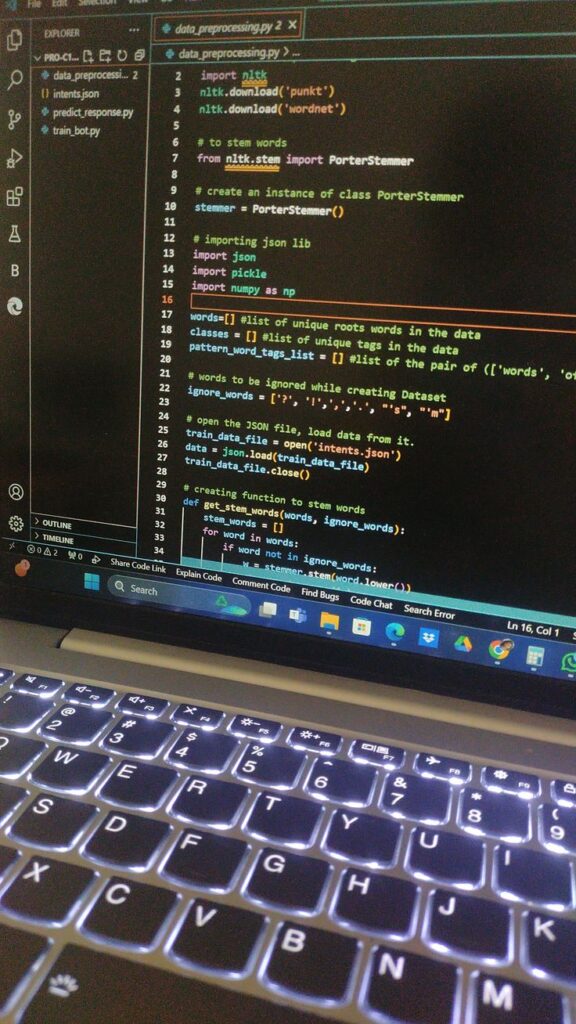 Python code for data preprocessing on a laptop screen with a backlit keyboard.