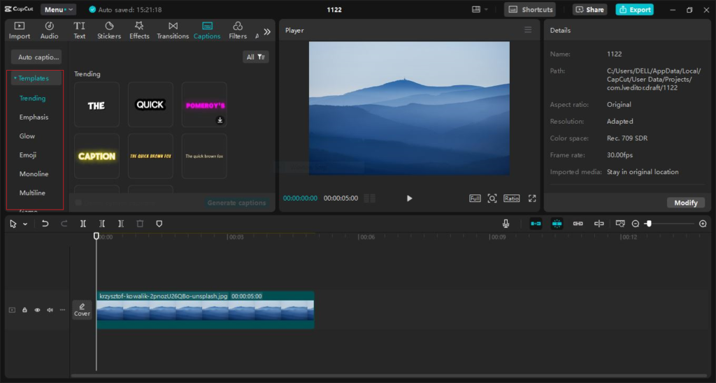 Video editing interface with a scenic blue mountain range displayed in the preview window.