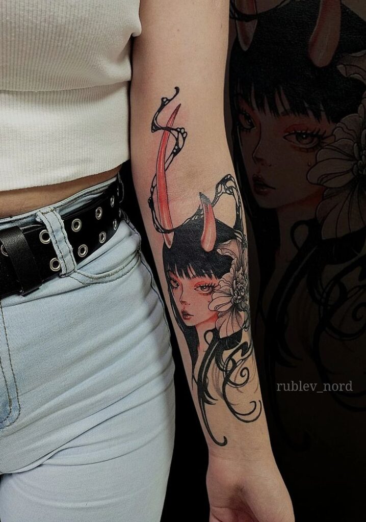 Colorful tattoo of a woman with horns and a flower on an arm, showcasing artistic and detailed design.