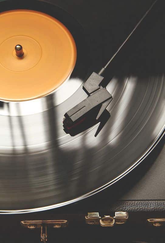 Close-up of vintage turntable playing a spinning vinyl record.