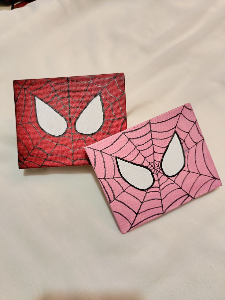 Two mini Spider-Man inspired canvases with red and pink spider web designs on a white background.