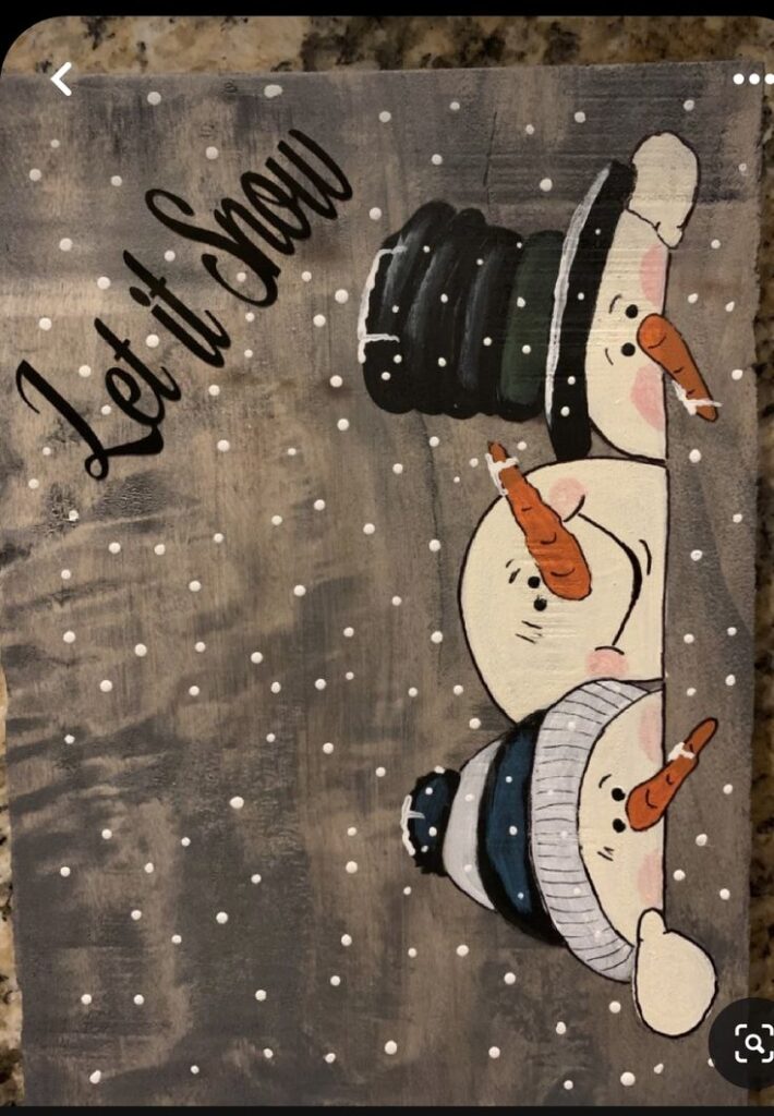 Snowmen peeking over a snowy background with Let it Snow text beside them.