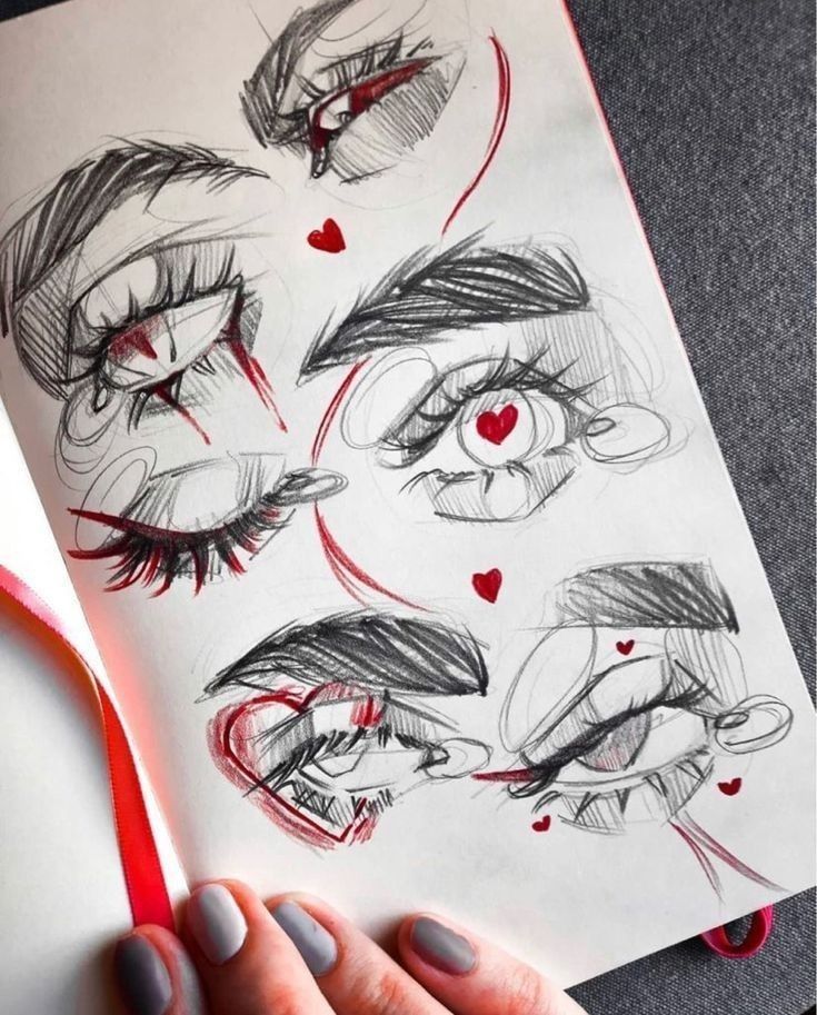 Sketchbook page with expressive eye drawings and red hearts.