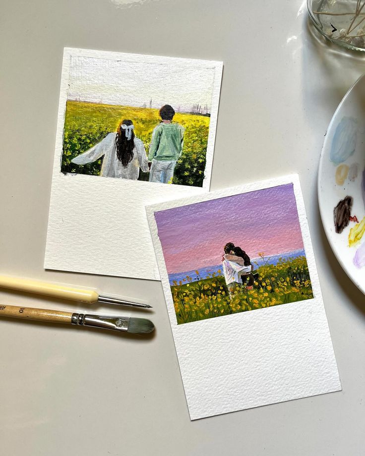 Two painted postcards of a couple in a field with brushes and a palette nearby, evoking love and creativity.