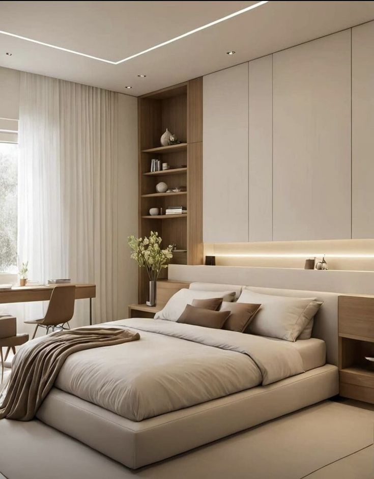 Modern bedroom with beige tones, minimalist furniture, built-in shelves, and natural light from a large window.