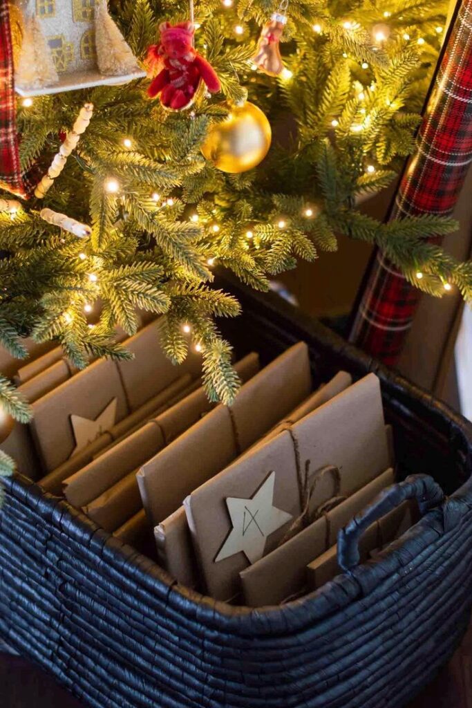 Cozy Christmas tree with lights, gifts wrapped in brown paper, and star tags in a wicker basket underneath.