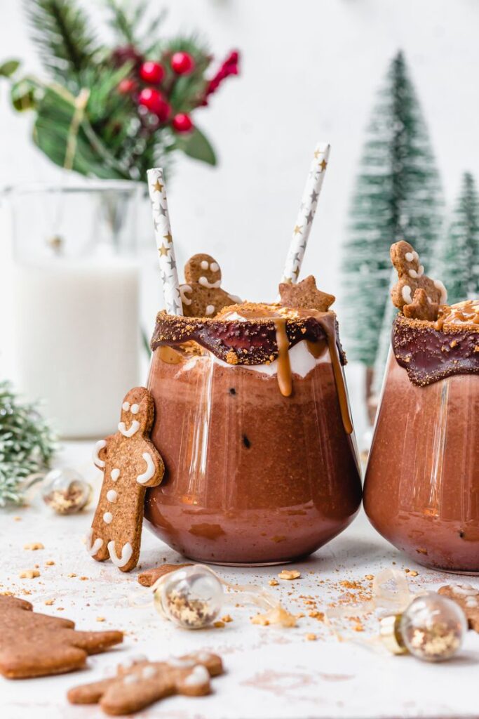 Festive gingerbread hot chocolate with decorative cookies and holiday accents, perfect for cozy winter celebrations.