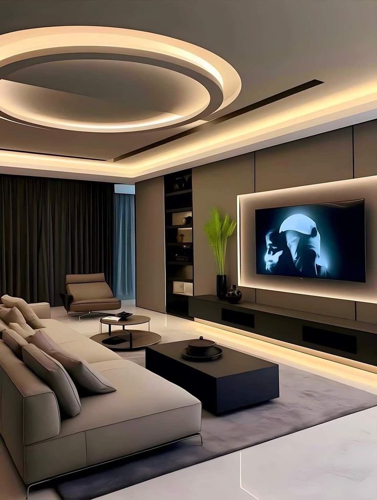 Modern living room with sleek gray furniture, circular ceiling lighting, and a large TV.