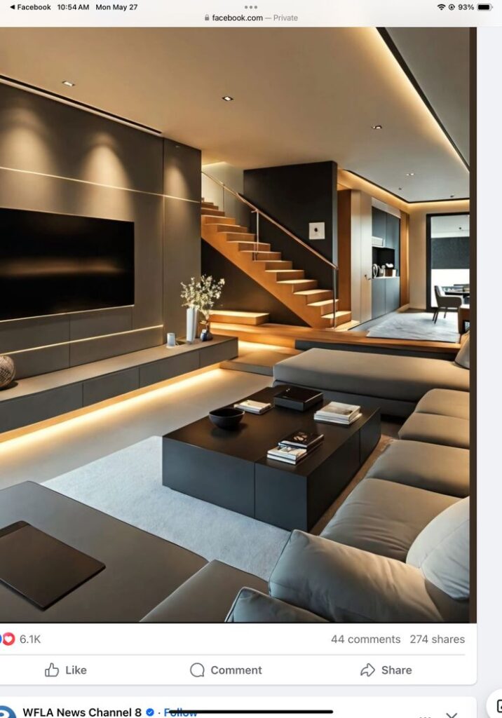 Modern living room with sleek interior design, warm lighting, and a stylish staircase leading to an upper level.