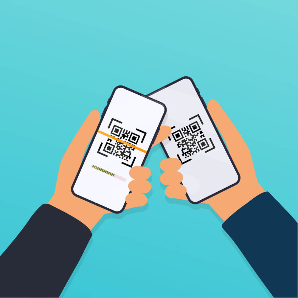 Two hands holding smartphones with scanning QR codes, symbolizing digital payment or connection.