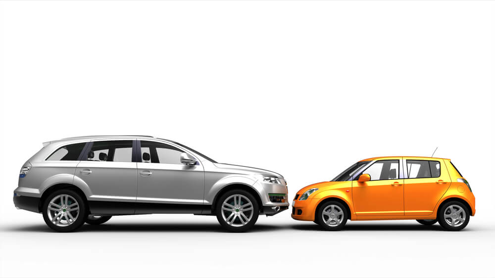 Silver SUV and orange compact car facing each other on a white background.