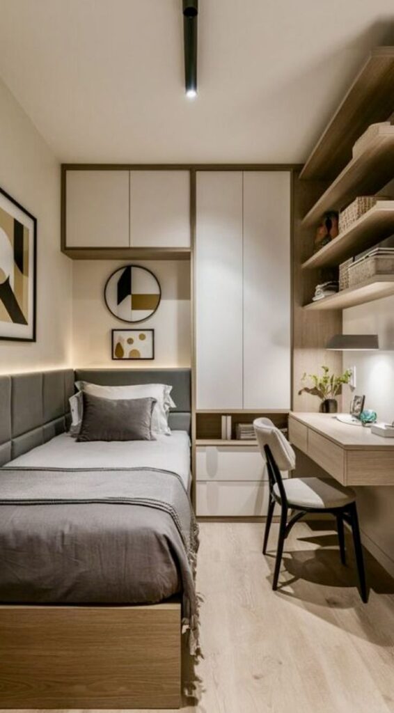 Compact modern bedroom with cozy gray bed, built-in shelves, desk, and minimalist decor.