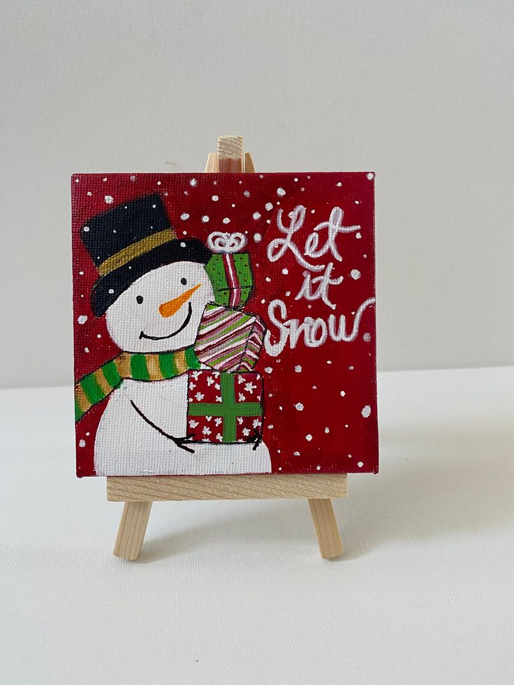 Festive snowman holding gifts with Let it Snow text on red background, perfect for holiday decor.