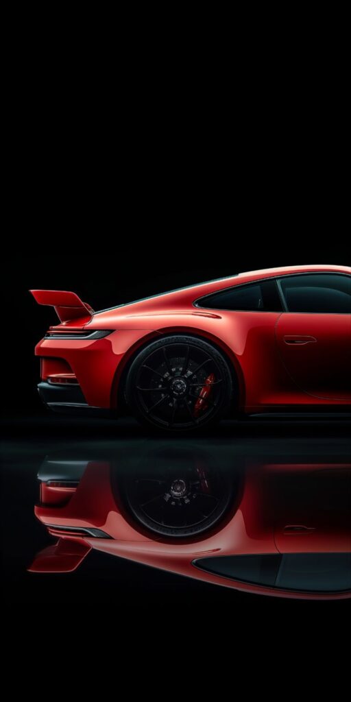 Sleek red sports car with a rear spoiler, reflecting on a dark glossy surface, showcasing luxury and speed.