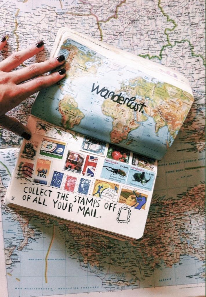 Notebook with world map and stamps collection, labeled Wanderlust and Collect the stamps off all your mail.