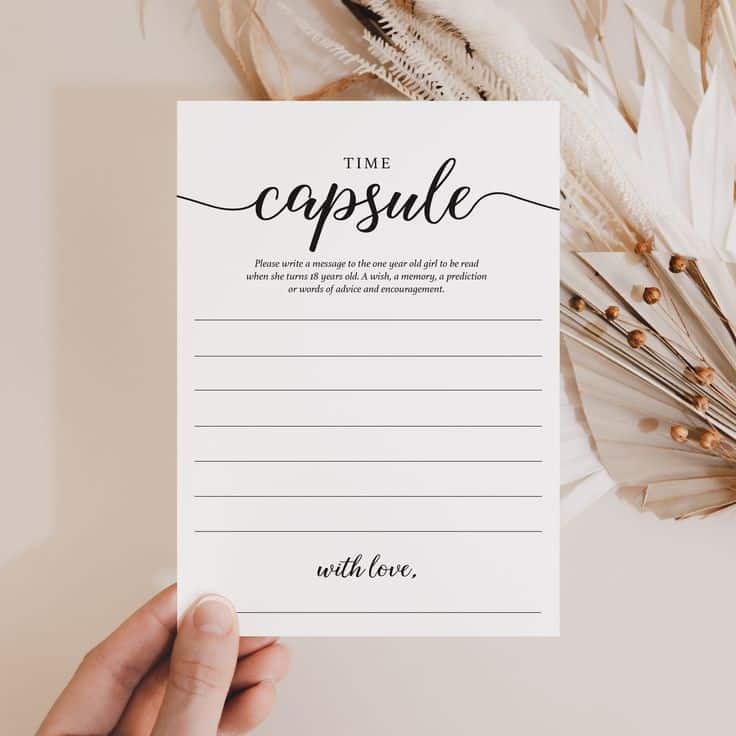 Time capsule message card with elegant script, held by a hand, against a natural dried floral background.