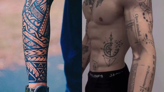 Detailed arm and torso tattoos on display, featuring tribal patterns and geometric designs.