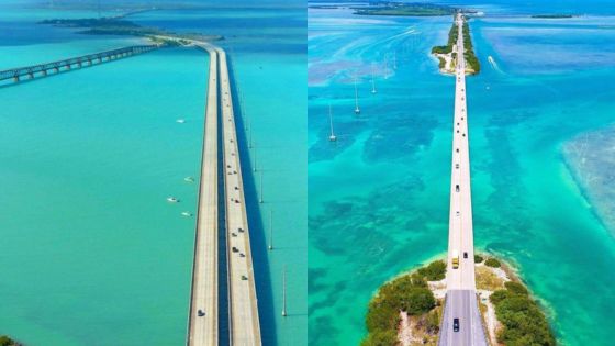 Aerial view of a long bridge over turquoise ocean waters, connecting islands under a clear blue sky.