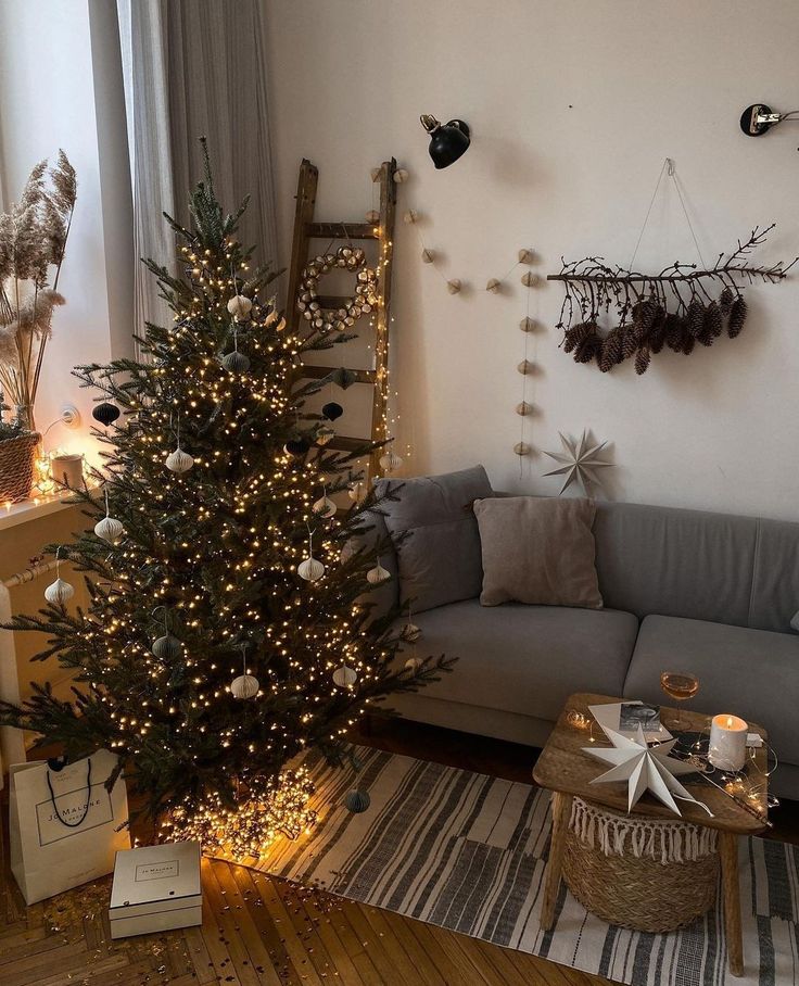 Cozy living room with a decorated Christmas tree, string lights, and festive decor. Warm holiday ambiance.