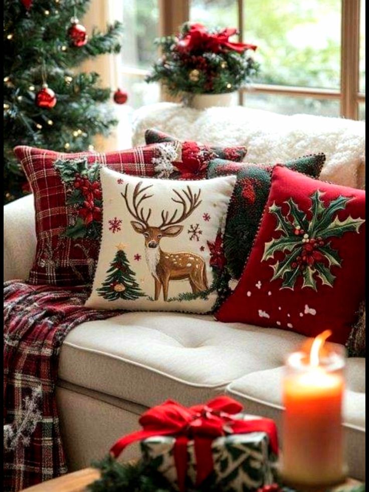 Cozy Christmas-themed sofa with decorative reindeer pillows, tree decor, and a lit candle for festive ambiance.