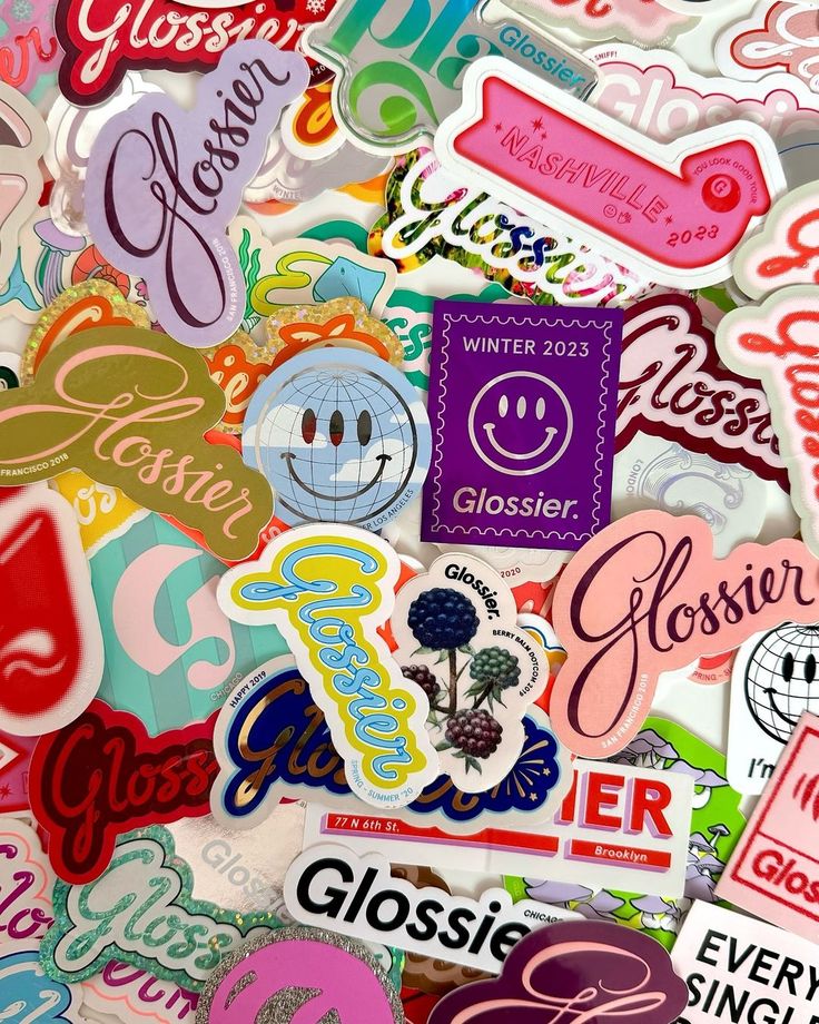 Colorful Glossier stickers collage featuring various designs and logos, showcasing vibrant brand identity.