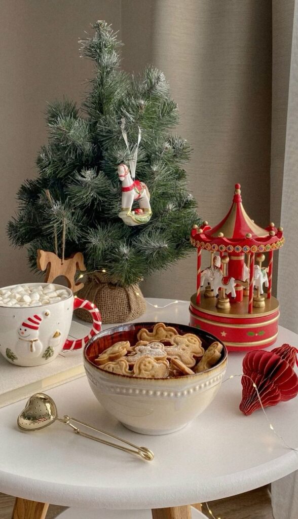 Cozy holiday scene with Christmas tree, cookies, and hot cocoa on a table, evoking festive warmth and charm.