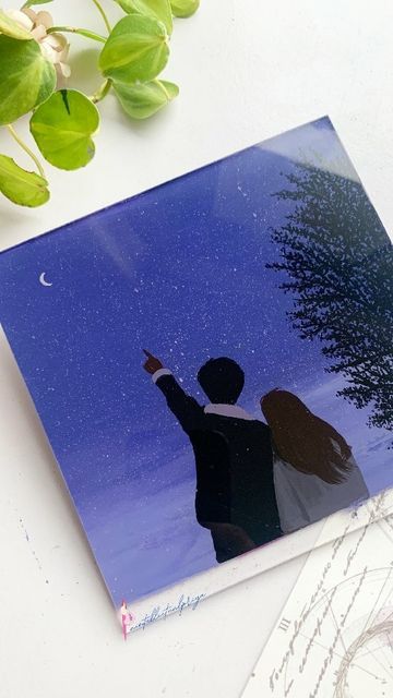 Couple stargazing at a starry night sky with crescent moon, surrounded by nature and capturing a romantic moment.