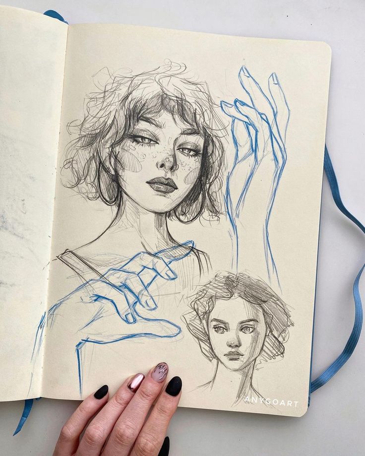 Sketchbook page with expressive hand and face sketches, showing detailed pencil and ink art techniques.