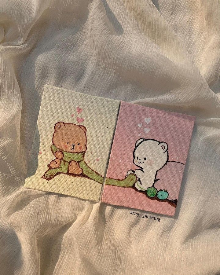 Cute bear drawings with hearts and yarn on canvas, displayed on a soft, textured fabric background.