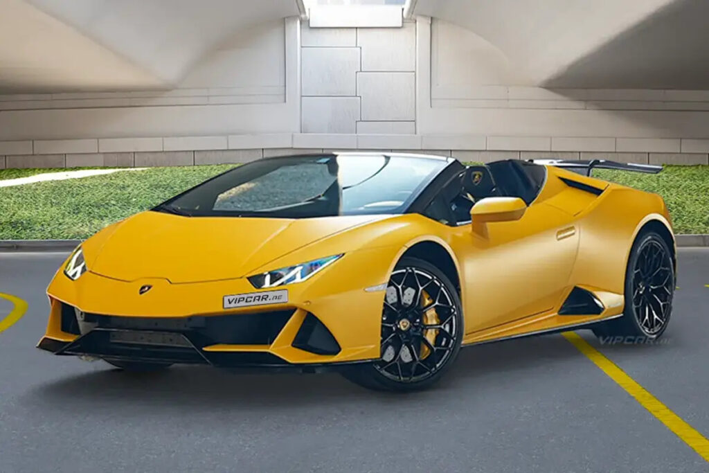 Yellow luxury sports car parked in a modern garage setting.