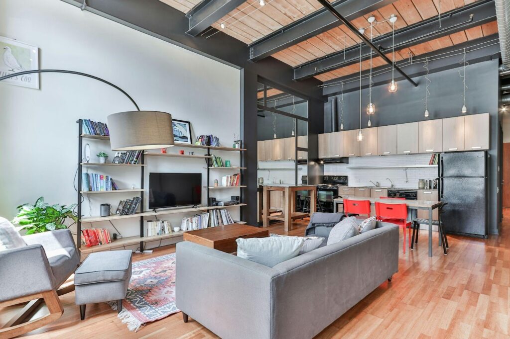 Modern loft with open kitchen, cozy living area, sleek furniture, and stylish lighting.