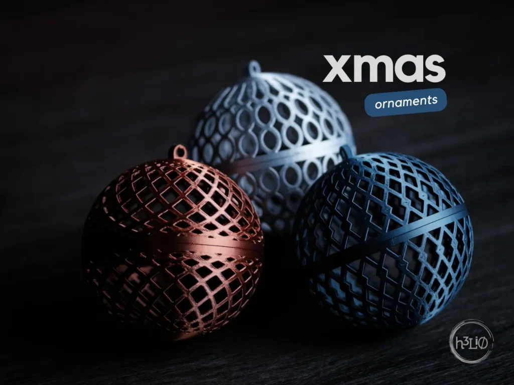 Three metallic Christmas ornaments in red, silver, and blue on a dark background.