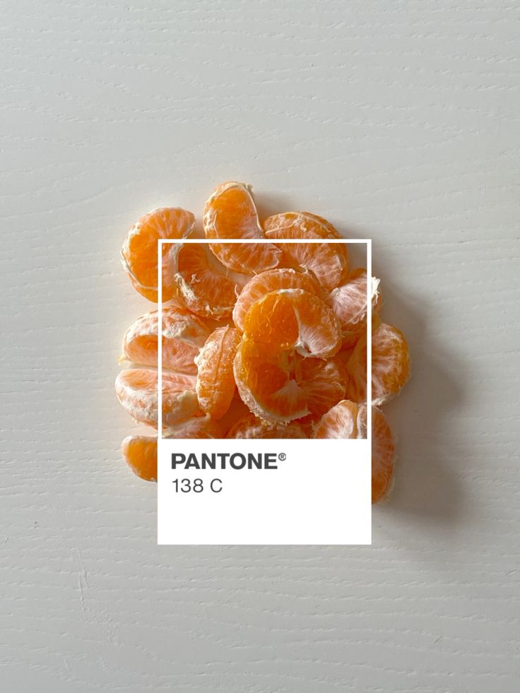 Sliced oranges resembling Pantone 138 C, highlighting vibrant citrus color against a light background.