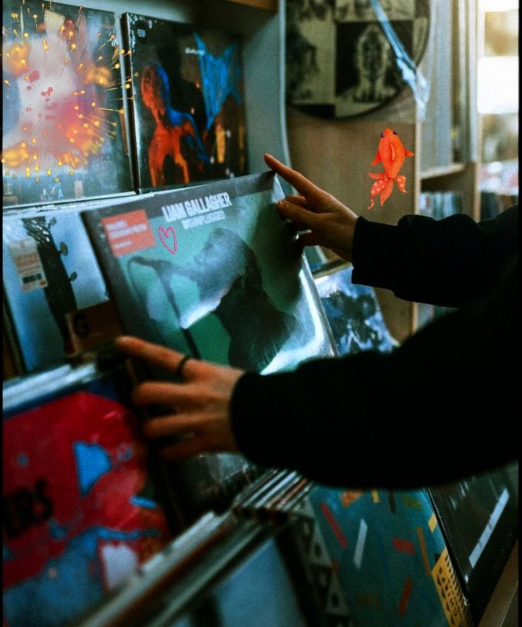 Person browsing vinyl records in a music store, showcasing album covers with colorful designs.