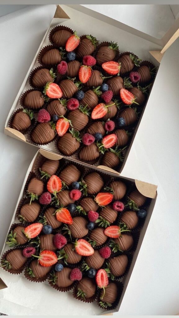 Boxes of chocolate-covered strawberries and assorted berries, perfect for a gourmet treat or special occasion.