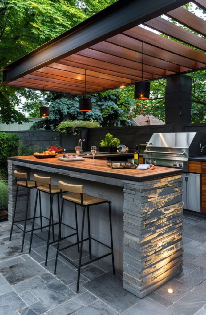 Modern outdoor kitchen with stone bar, wood pergola, and grill. Stylish patio seating and ambient lighting for dining.