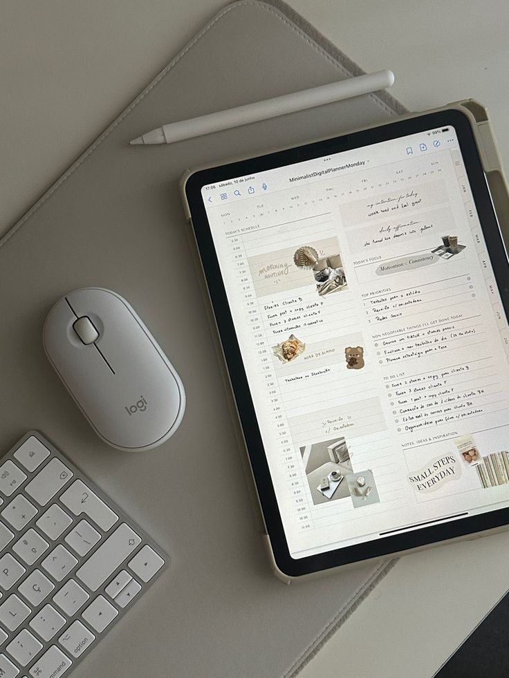 Digital planner on tablet with pen, mouse, and keyboard on desk. Organized minimalist workspace.