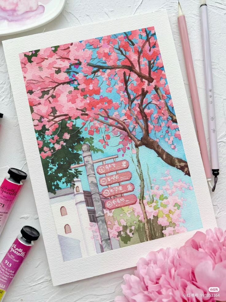 Watercolor painting of cherry blossoms with a signpost, paint tubes, and pencils on a textured surface.