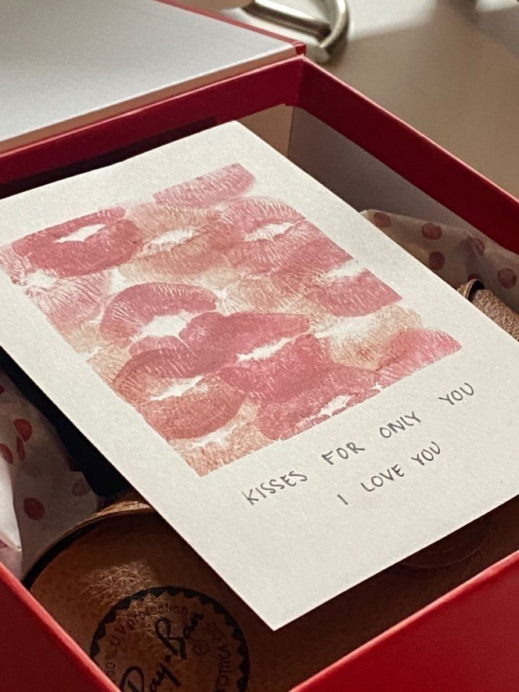 Romantic card with lipstick marks and Kisses for only you, I love you message in a red gift box.