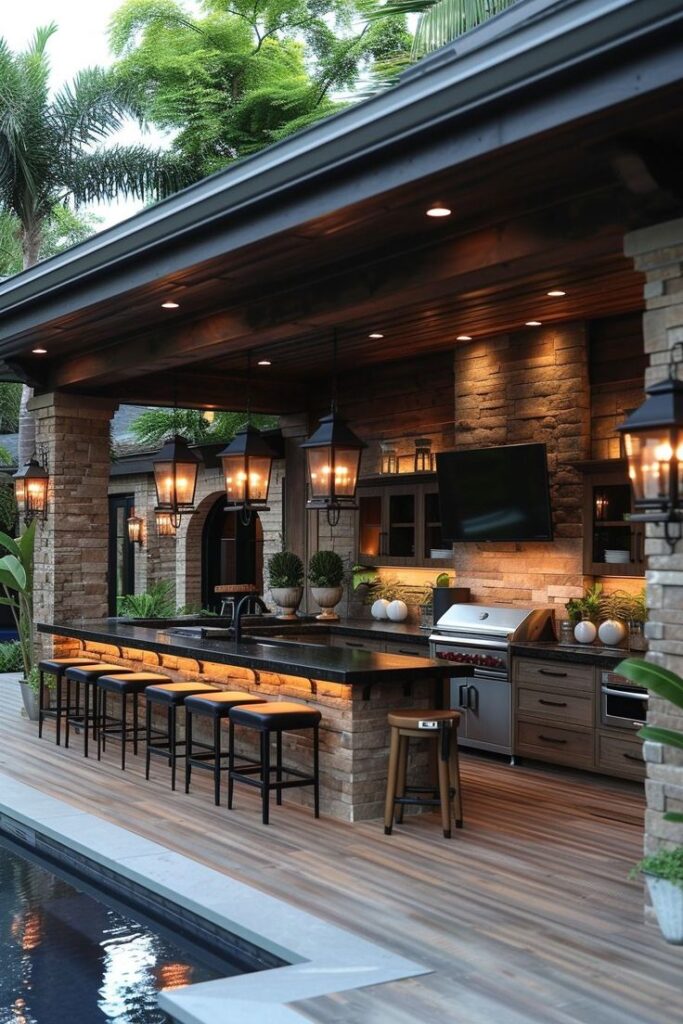 Luxurious outdoor kitchen with bar seating, pendant lights, and poolside ambiance in a leafy backyard setting.