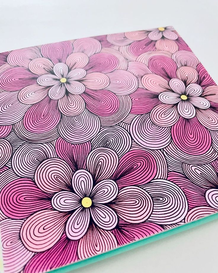 Pink and purple floral pattern with intricate line details on a decorative notebook cover.