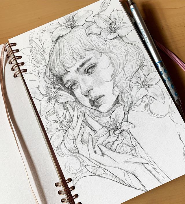 Pencil drawing of a woman surrounded by flowers, sketchbook art with detailed floral elements.