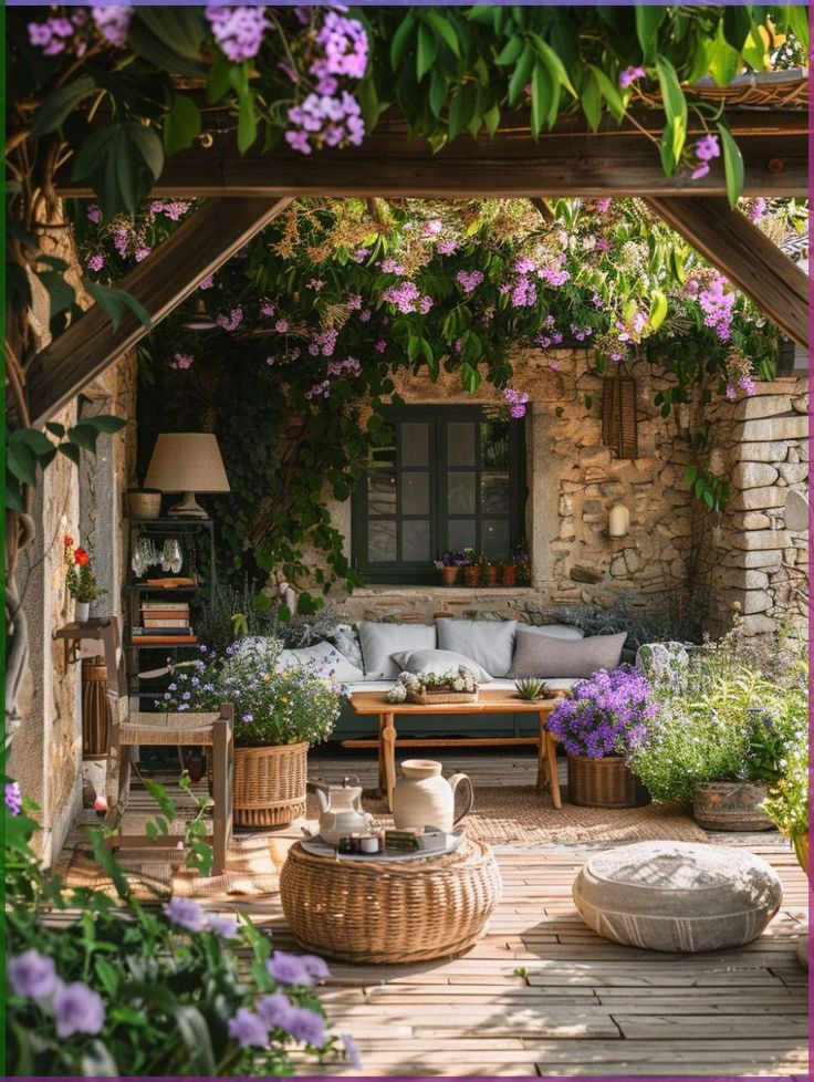 Cozy garden patio with wicker furniture, blooming purple flowers, and lush greenery under a pergola.