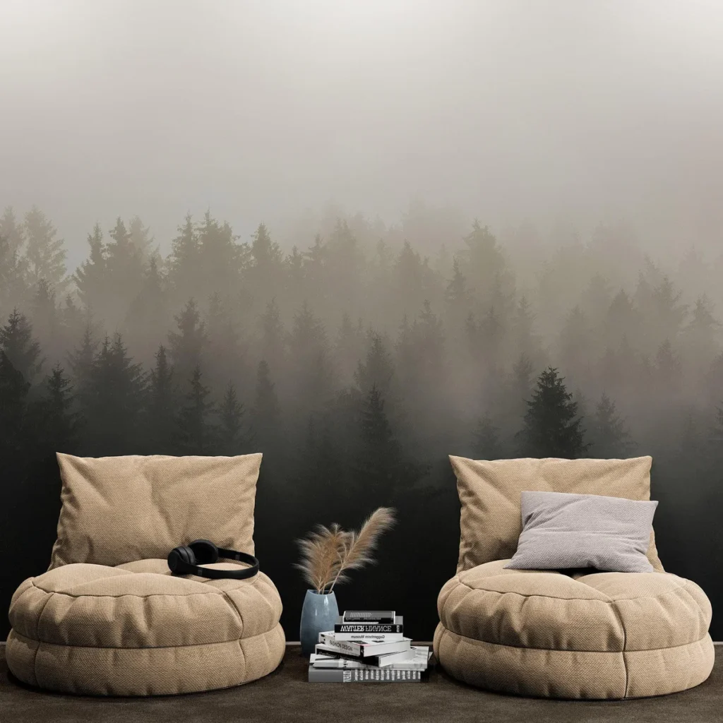 Cozy beige chairs with cushions, headphones, books, and vase; misty forest wallpaper background for a tranquil vibe.