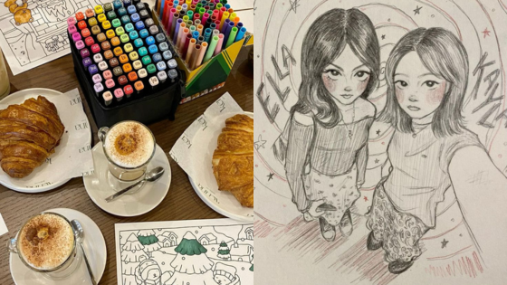 Coffee, croissants, and art supplies next to a sketch of two girls with Ella and Kana names, surrounded by stars.