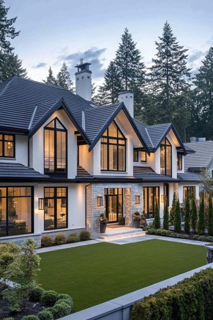 Luxurious modern mansion with large windows, landscaped garden, and forest backdrop at twilight.