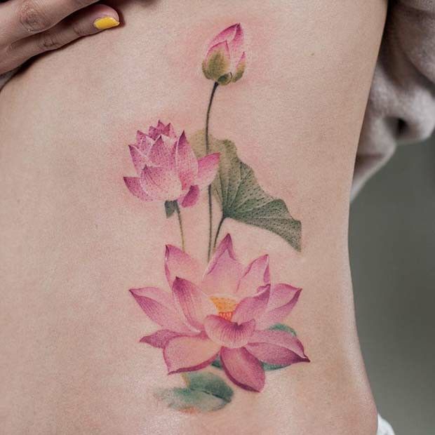 Delicate pink lotus flower tattoo on skin, showcasing floral elegance and intricate design.